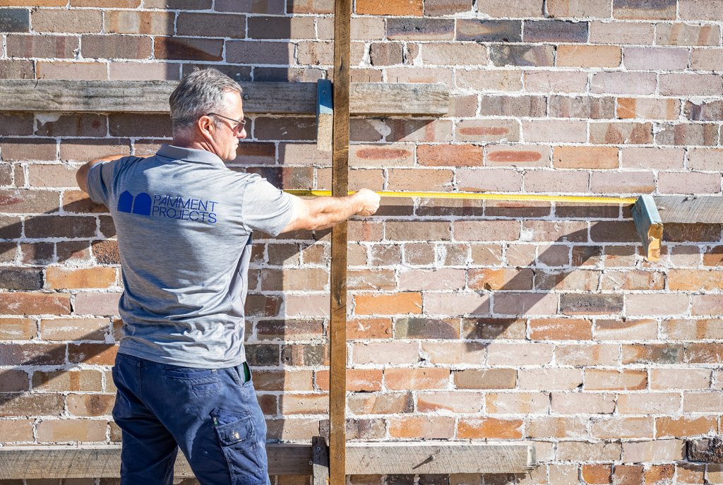 Site Manager in Dover Heights, Measuring Up the Brick Wall.